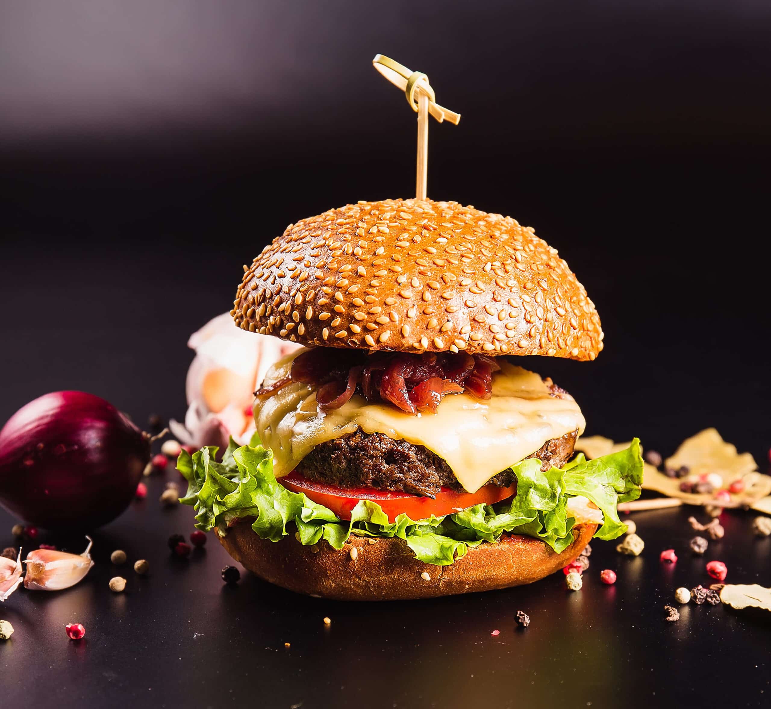 Juicy,Delicious,Burger,With,Spices,On,A,Black,Background